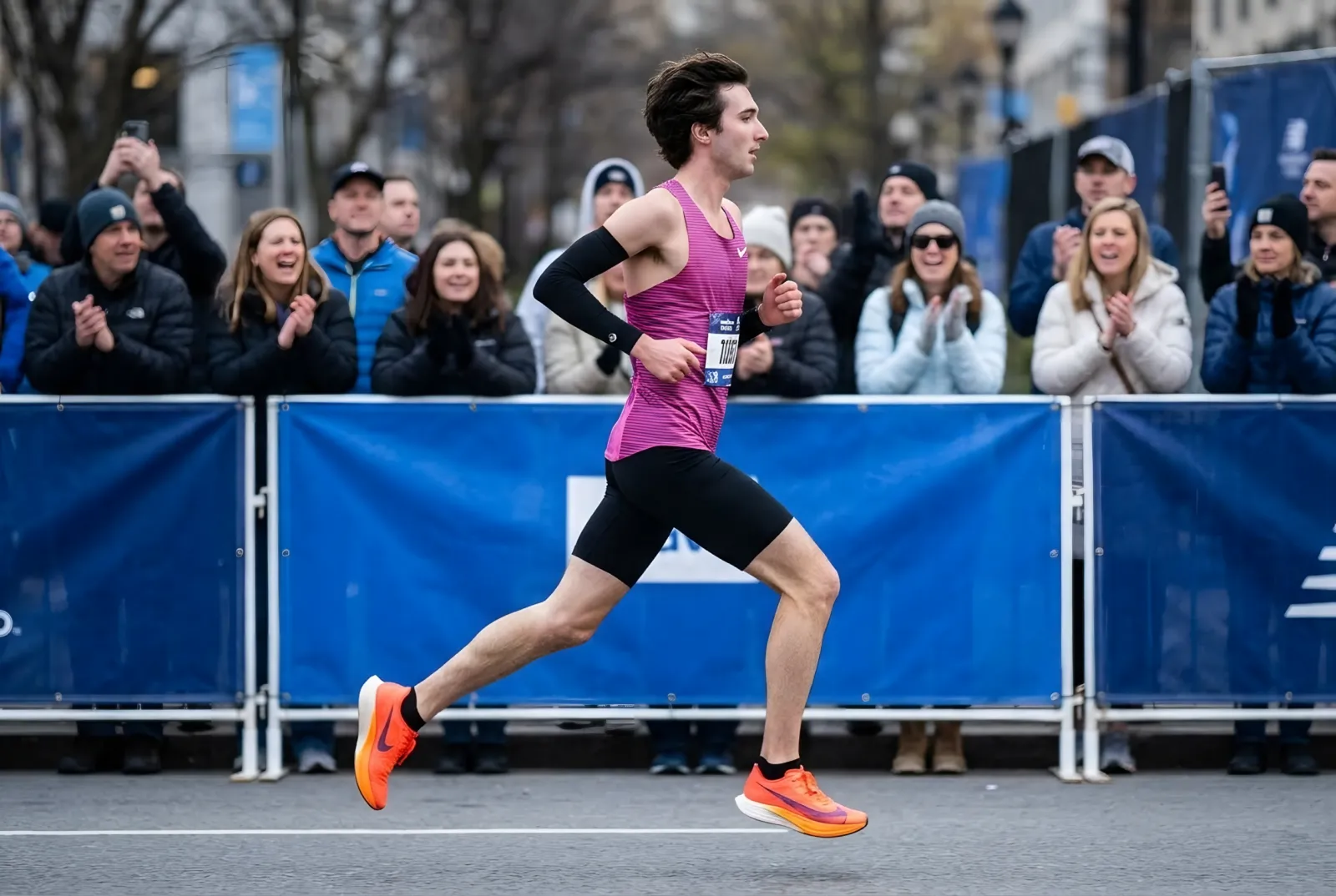 Cade racing a city road race in a pink and purple singlet
